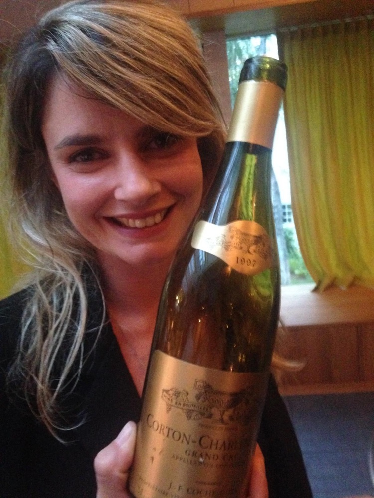 Laurence Gensac holding a bottle of Corton-Charlemagne Grand Cru